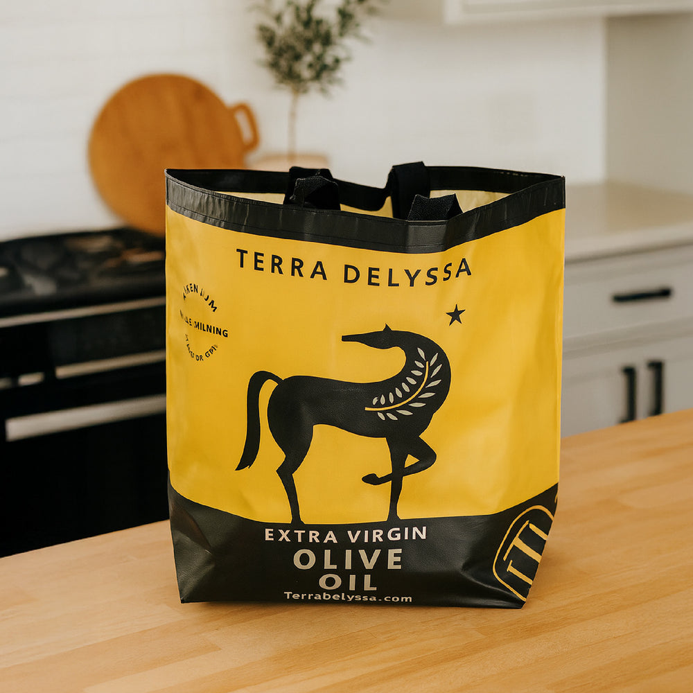 
                  
                    Eco-friendly yellow Terra Delyssa reusable shopping bag featuring the classic horse logo, displayed on a kitchen counter to highlight its stylish design and everyday practicality.
                  
                