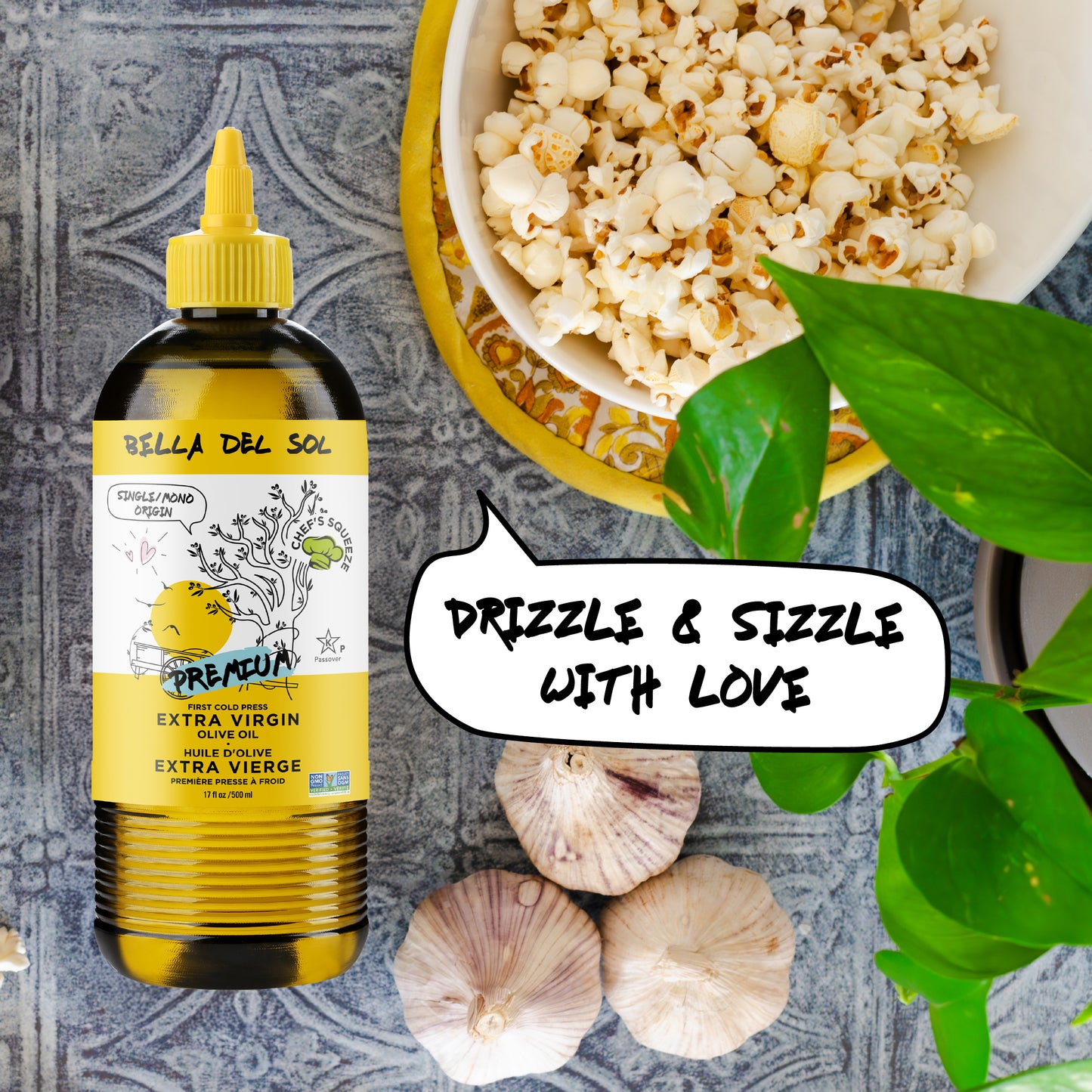
                  
                    Bella Del Sol Extra Virgin Olive Oil chef squeeze bottle next to a bowl of popcorn, garlic, and herbs with text “Drizzle & Sizzle With Love” – healthy cooking inspiration
                  
                