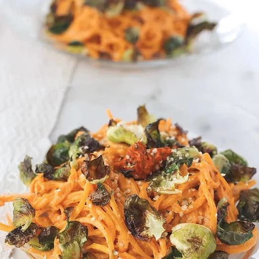 Butternut Squash Noodles With Harissa Cashew Cream And Crispy Brussels Sprout Chips